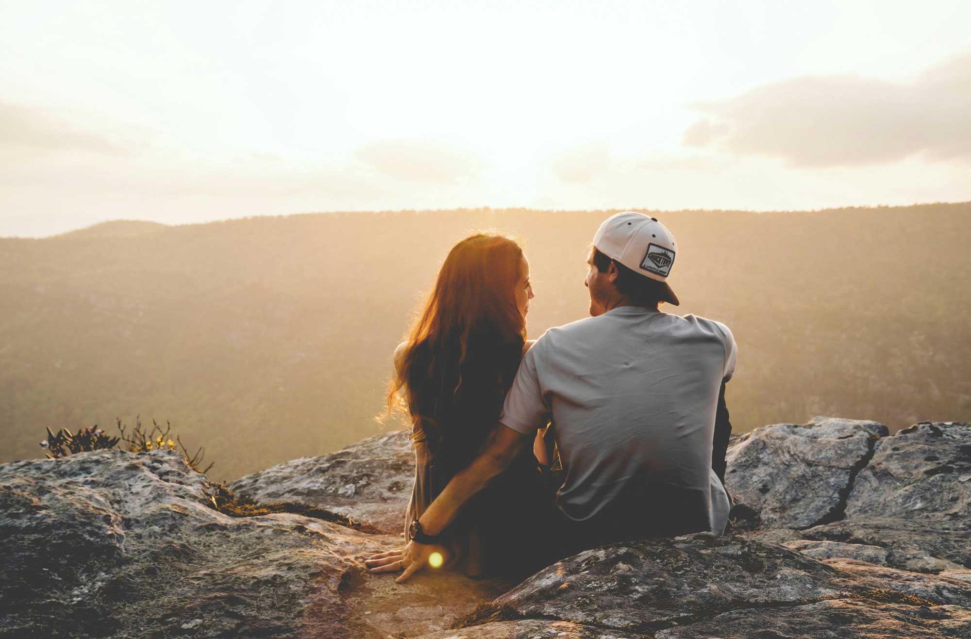 Man and woman sitting on a rock