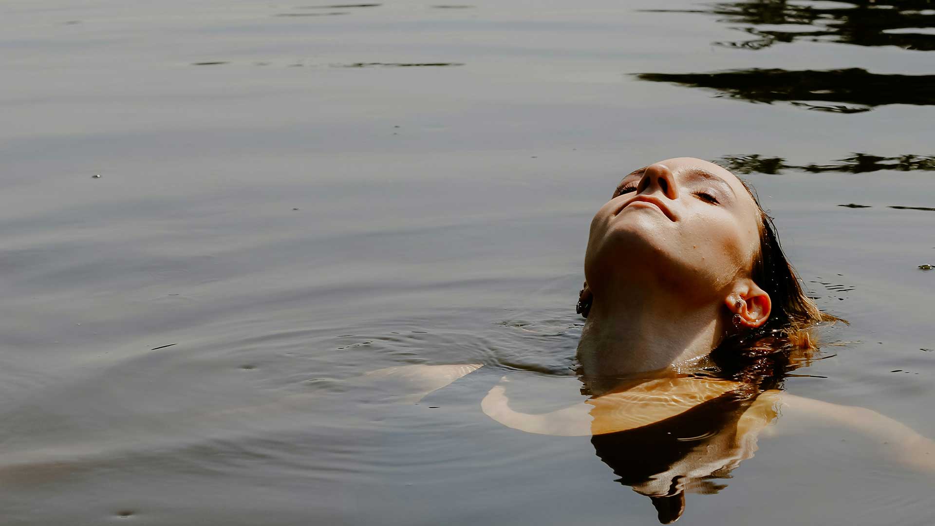 Woman lying back in the water